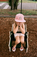 Pink kids corduroy hat with a rainbow design 